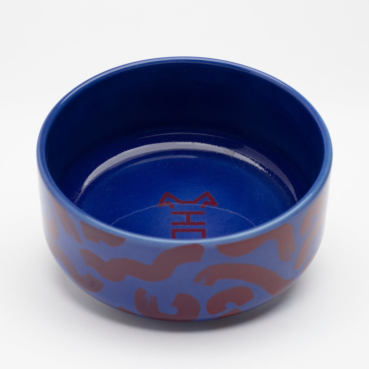 Side view of Flow ceramic dog bowl by Hot Doggies with red and blue pattern, 150 mm diameter, 65 mm height, durable and dishwasher safe.