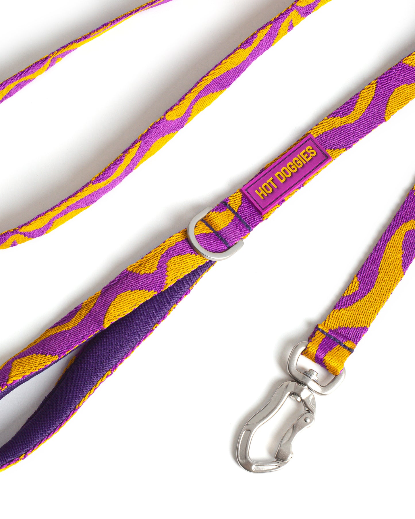 Purple and yellow patterned dog leash with a silver clasp on a white background.