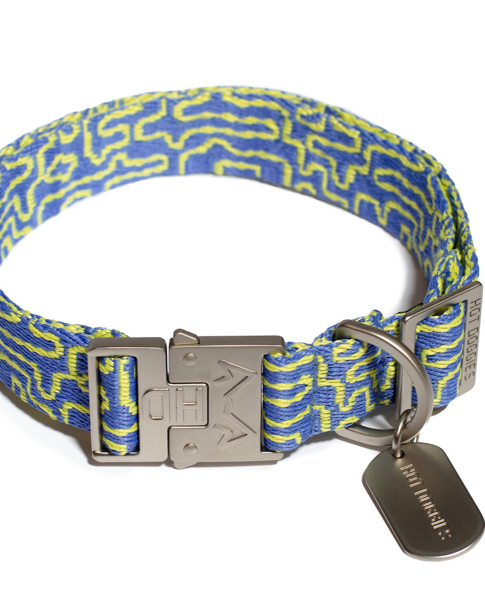 Flat lay image of a woven high quality collar with a blue and lime geometric pattern, crafted from recycled polyester.