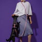 Hot Doggies Hands Free Dog Leash in Lily Coral – adjustable and eco-friendly, styled with fashion model feeding black dog on vibrant purple background.