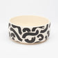 Side view of Hot Doggies Monochrome Ceramic Bowl with black-and-white abstract design,