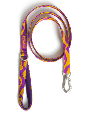 Dog leash with purple and yellow pattern on a white background.