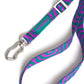 Dog leash with purple and teal pattern and silver clasp on a white background.