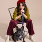 Woman sitting on a chair with a dog on a Lola Groove Classic Leash , wearing a red beret and green sweater.