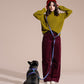 Woman in green sweater and red beanie with a dog on a LOLA GROOVE HANDS-FREE LEASH against a beige background.