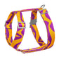 Dog harness with purple and yellow pattern on a white background