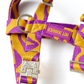 Purple and yellow patterned dog harness with metal buckle on a white background