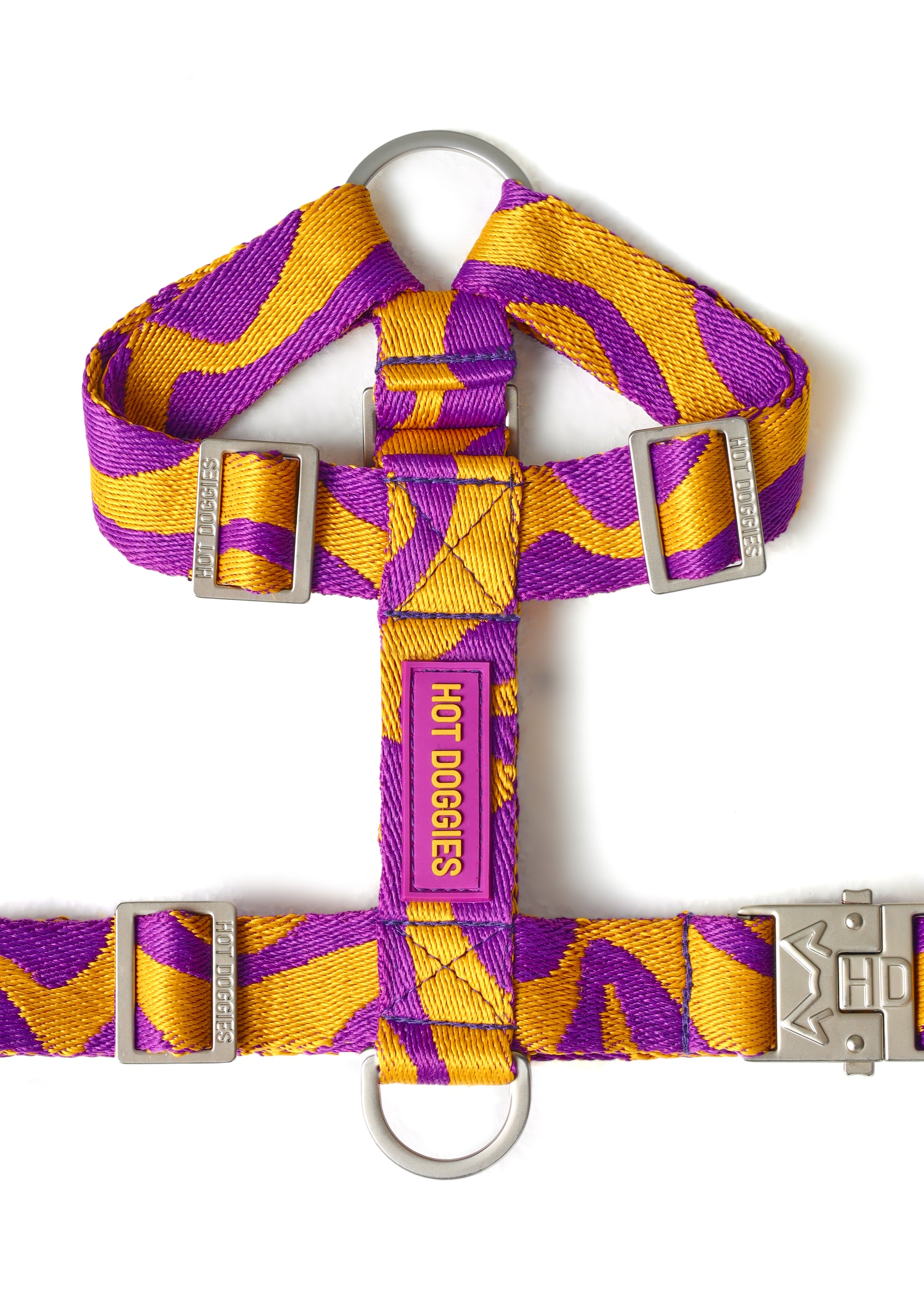 Purple and yellow striped dog harness with metal buckles on a white background