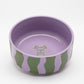 Front view of Hot Doggies Groove Stripes ceramic bowl with bold green and purple stripe design, dishwasher-safe, sturdy, ideal for serving food or water for small and medium dogs.