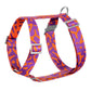 Dog harness with purple and orange pattern on a white background.