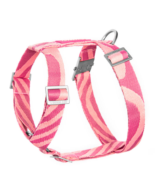 Pink and red striped dog harness on a white background.